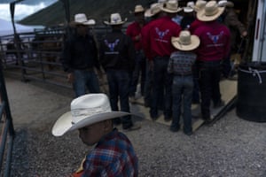 People gather for a meeting before the start of bull riding competitions at Jackson Hole Rodeo in Wyoming