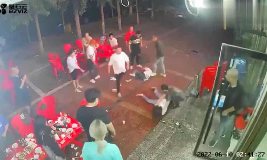 A CCTV image shows two women on the ground outside the restaurant in Tangshan, China