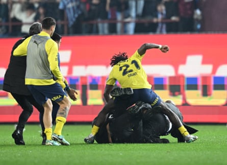 Bright Osayi-Samuel gets involved in a clash with a Trabzonspor fan.