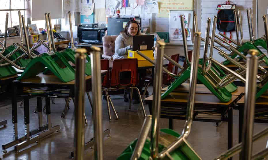 A teacher interacts with students virtually from an empty classroom in Louisville, Kentucky, on 11 January.