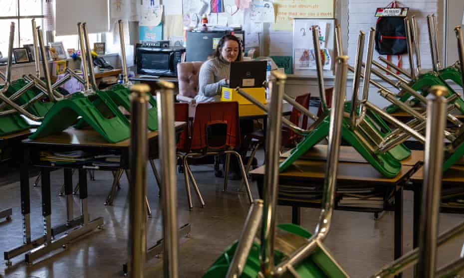 A teacher interacts with students virtually from an empty classroom in Louisville, Kentucky, on 11 January. 