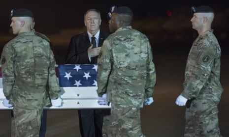 The US secretary of state, Mike Pompeo, watches as an army carry team moves a transfer case containing the remains of Sgt 1st Class Elis Barreto Ortiz, 34, from Morovis, Puerto Rico, at Dover air force base, Delaware.