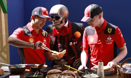 Charles Leclerc gets a fright from a costumed performer in Mexico City.