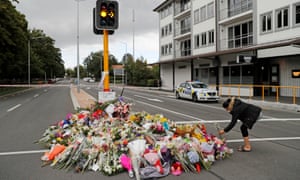 Large pile of floral tributes at a traffic light in Christchurch