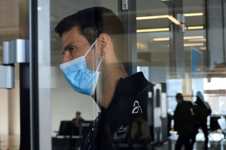 Novak Djokovic wears a mask at an airport