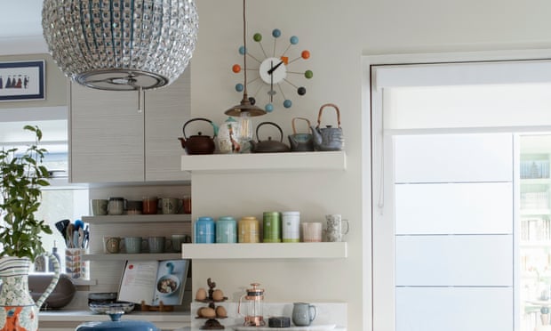 Kitchen shelving with colourful pots and a large bright window