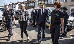LONDON, UNITED KINGDOM - MAY 21:  Prime Minister David Cameron and Home secretary Theresa May are accompanied by immigration enforcement officers into a home in  Southall in London following an early morning raid on the property that yielded three arrests of illegal immigrants, on May 21, 2015 in London, England. Despite pledging in 2010 to reduce migration numbers to less than 100,000, new immigration figures reveal that net migration to the UK reached 318,000 last year, the highest in a decade, increasing more