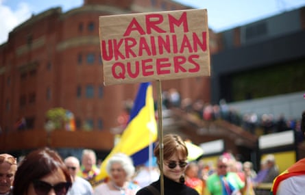 Crowd and sign saying ‘Arm Ukrainian queers’.