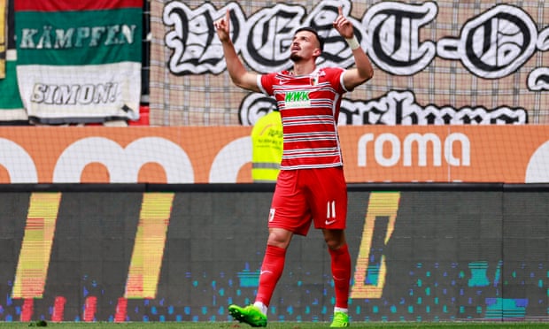 Augsburg’s Mergim Berisha celebrates the goal that extended Bayern’s spell in the doldrums.