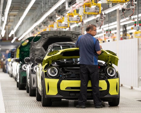 Man stands in front of yellow Mini