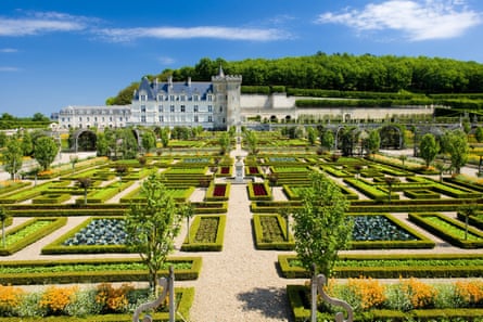 Formal gardens with a chateau in the distance.