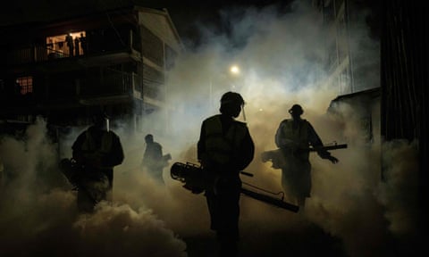 Volunteers fumigate a street in Nairobi in April.