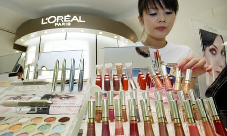 A beauty consultant adjusts cosmetics at a L’Oreal counter. The French firm has said it will phase out microbeads by 2017. 