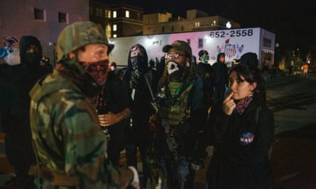 A militia man and armed protester engage in conversation in Kenosha, Wisconsin.
