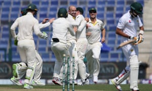 Nathan Lyon of Australia celebrates with teammates after dismissing Babar Azam.