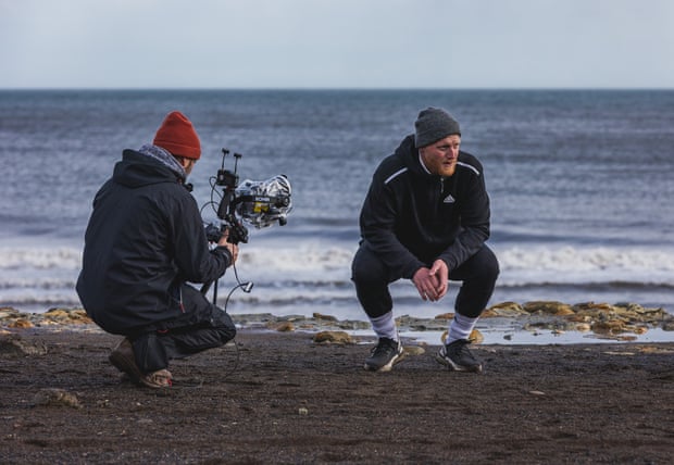 A scene from Ben Stokes: Phoenix from the Ashes, with Stokes crouching on a beach.