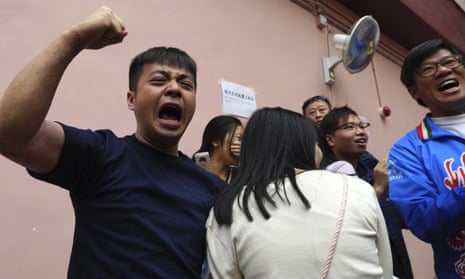 Supporters of a pro-democracy candidate cheer after winning a seat in the district council elections in Hong Kong