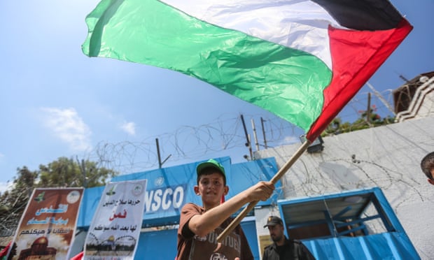 A Palestinian boy waves a flag during the protest against Israeli violations and restrictions against the al-Aqsa mosque, Gaza City.