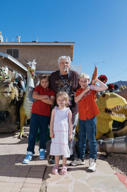 a family visiting the dinosaur-themed funhouse pose for a picture