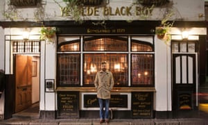 Adam, the landlord outside his pub, Ye Olde Black Boy.