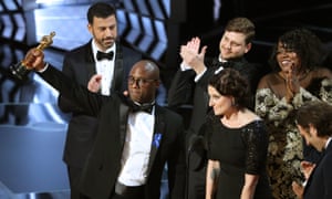 Moonlight director Barry Jenkins parades the best picture statuette.