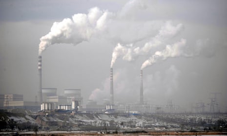 Smoke plumes billow from chimneys at a coal-fired power plant in Shanxi province, China.