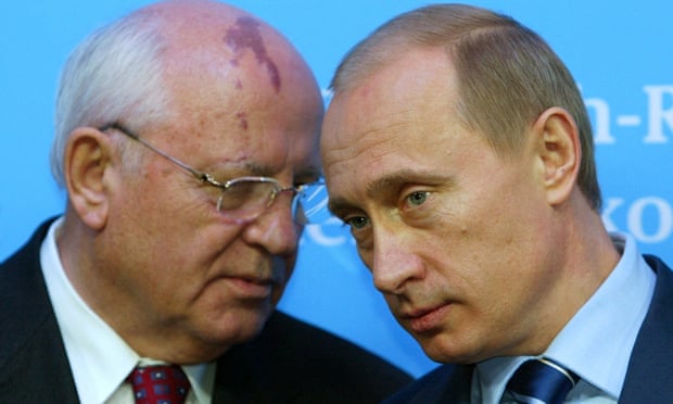 Vladimir Putin listens to Gorbachev during a news conference following talks with German chancellor Gerhard Schroder in 2004.