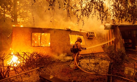 Ffirefighters battle flames at a burning apartment complex in Paradise, California, on 9 November.