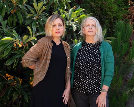 Corin Tucker and Tracy Sawyer standing against a bush