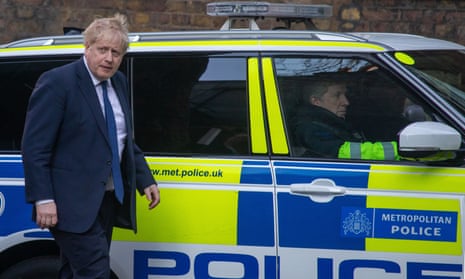 Boris Johnson  in front of a police car in Downing Street, March 2022