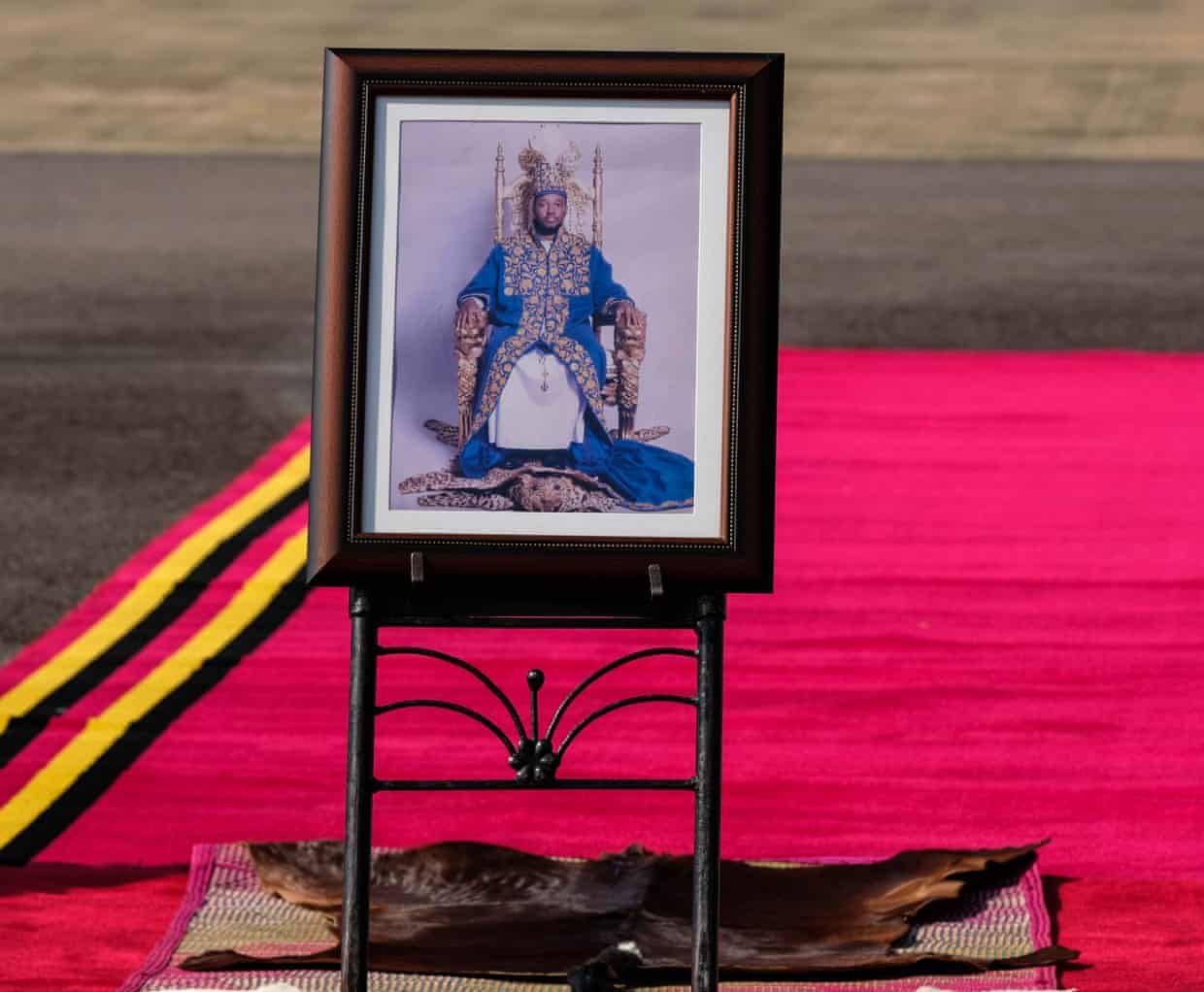 A portrait of the late king on the red carpet at Entebbe International airport.