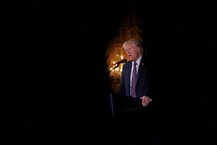 Man in silhouette speaks into mic