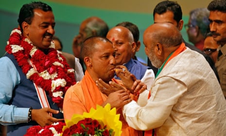 Yogi Adityanath is offered sweets after he was elected as chief minister of Uttar Pradesh.