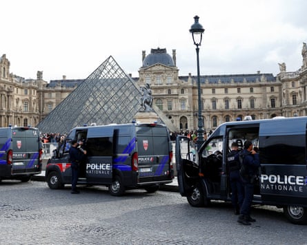 A row of police vans outside the Louvre
