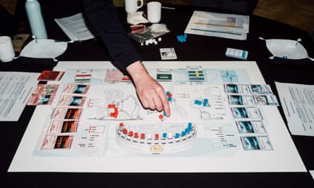 The hands of a war-gamer moving pieces on a map