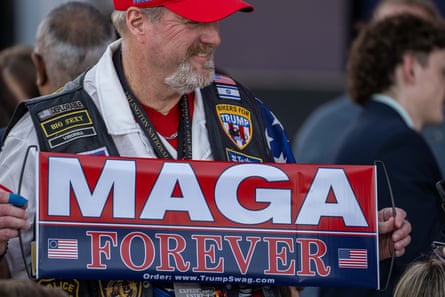 A man with a Maga sign