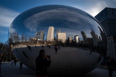 Buildings and people are reflected in The Bean, Millennium Park.