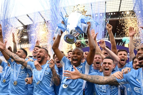 Fernandinho of Manchester City lifts the Premier League trophy.