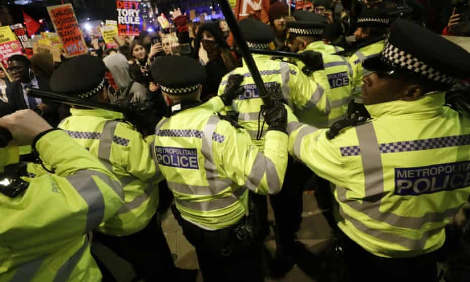 Police scuffle with anti-Boris Johnson marchers.