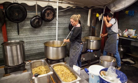 Volunteers with Refugee Community Kitchen preparing food for homeless migrants at Calais in 2016.