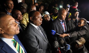 South African president Cyril Ramaphosa (centre) speaks outside Winnie Madikizela-Mandela’s home in Soweto