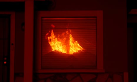 California wildfires: deadly blazes continue to grow as officials warn of shortage of firefighters – latest updates Flames from the Eaton Fire are reflected in the window of a house as powerful winds fueling devastating wildfires in the Los Angeles area force people to evacuate, in Altadena, California.