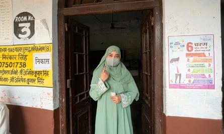 A Muslim voter shows her index finger marked with an indelible ink after casting her vote in the sixth round of polling in India’s national election.