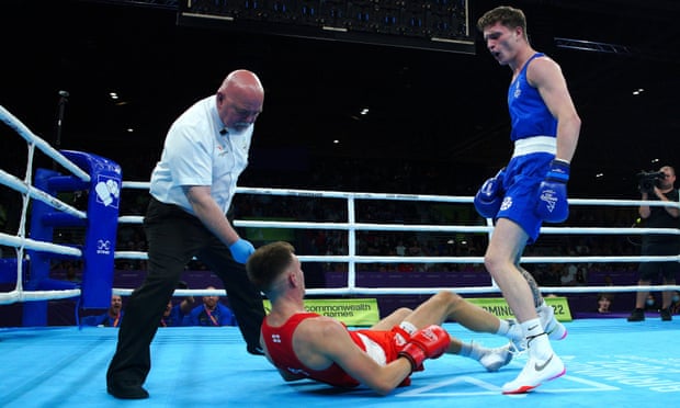 England’s Lewis Richardson (Red) is knocked down by Scotland’s Sam Hickey (Blue) in the Men’s middleweight semi-final at The NEC.