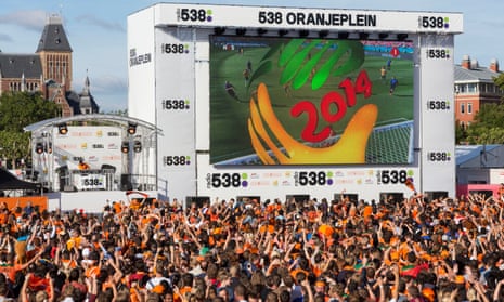  Fans in Amsterdam celebrate a Netherlands goal during a 2014 World Cup victory over Australia. There are no such scenes this summer.