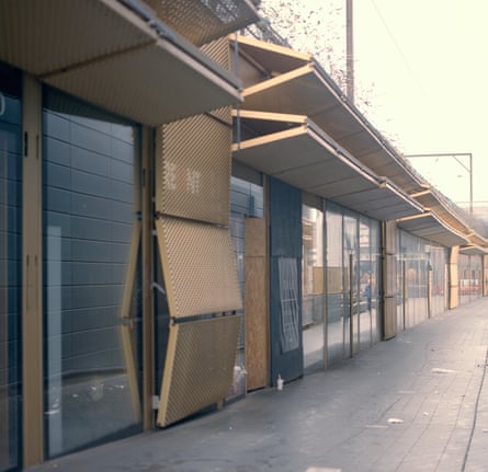 Broken gold shutters outside empty shops in Hackney Walk, east London