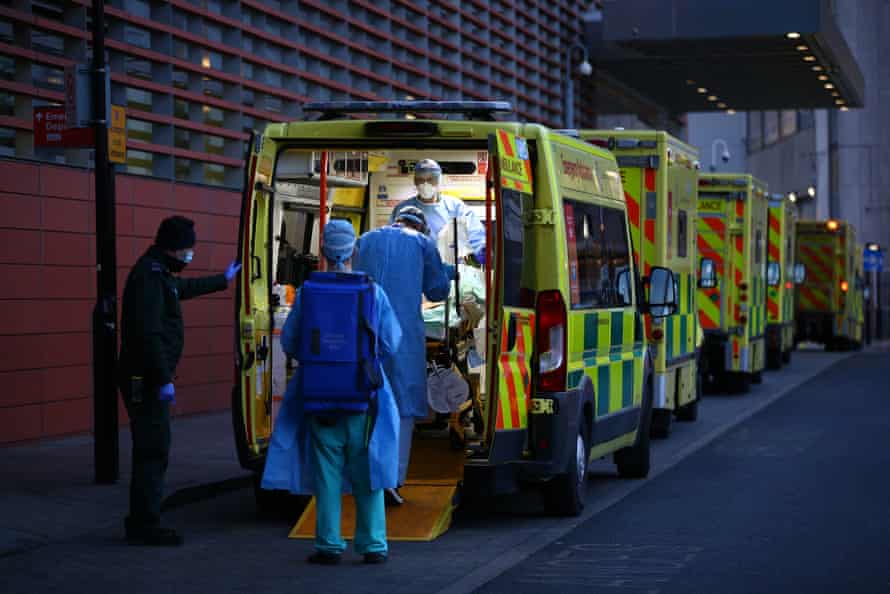 A patient is transported out of an ambulance by medics at the Royal London Hospital on January 2