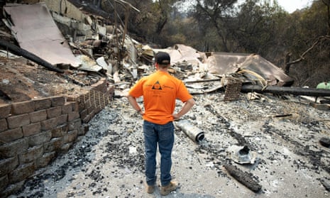 Gary Pratt inspects the ruins of his home at Spanish Flat Mobile Villa mobile home park near Lake Berryessa, California.