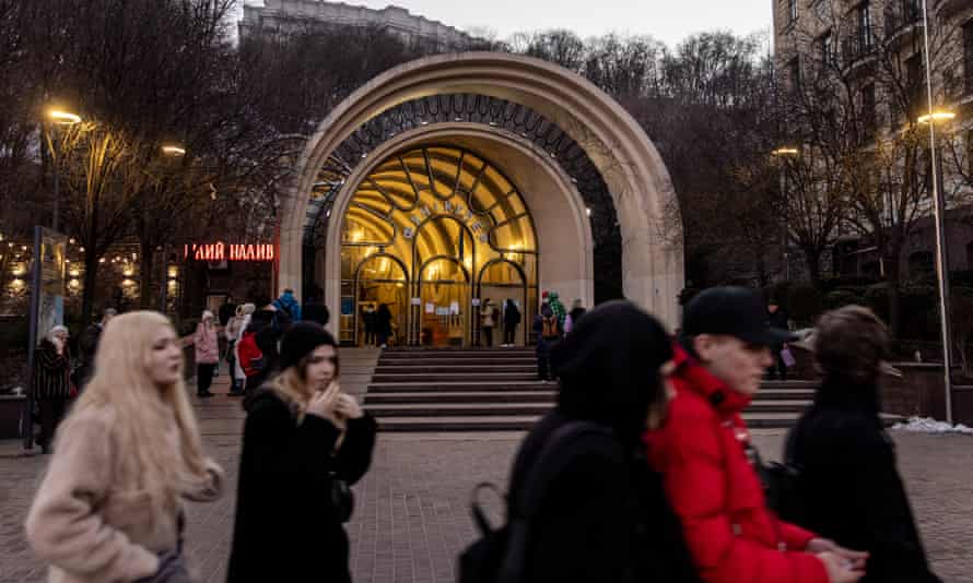 People walk past the entrance of a cable car station in Kyiv, Ukraine.