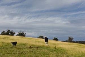 Bruce Pascoe with his dog Yambulla in the mandadyan nalluk grass on the hill above his property.